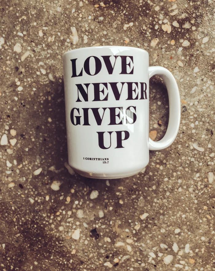 Love Never Coffee Mug